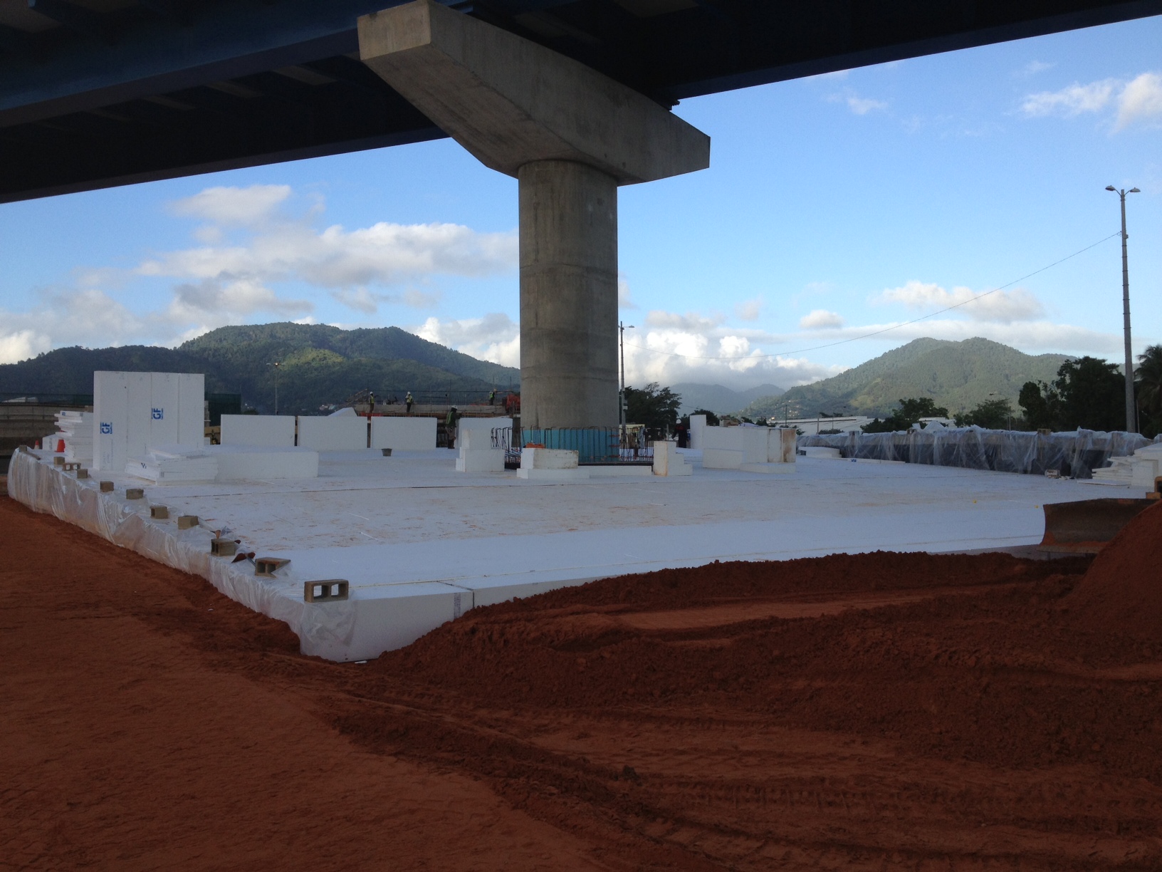 Working in the soft soils of Trinidad, the contractor specified EPS geofoam to reduce the load applied to the pile cap under the existing pier on this freeway interchange project.